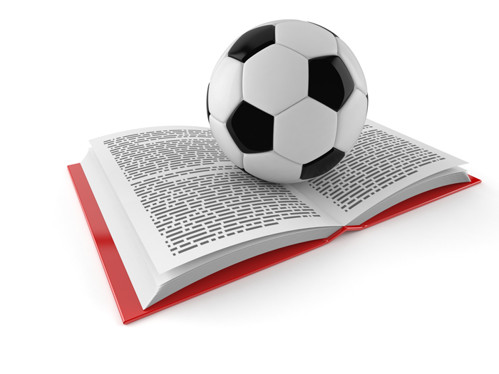 soccer ball on an open book