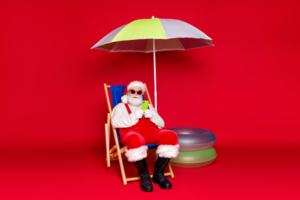 santa sitting under an umbrella